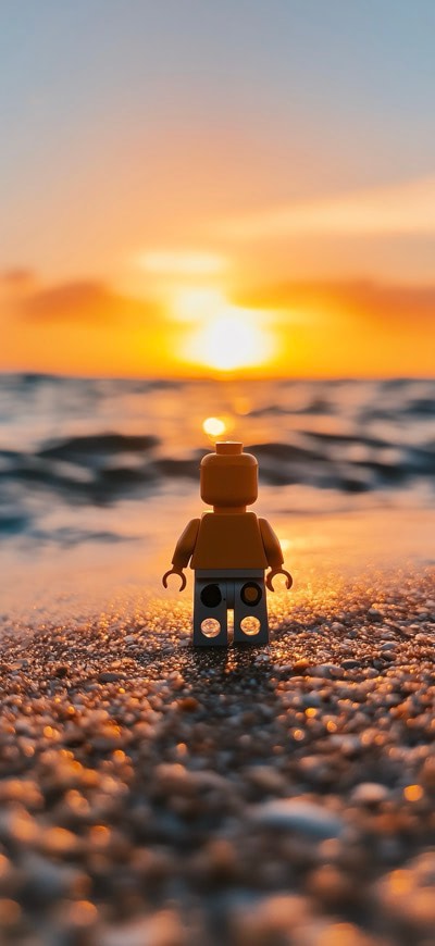 Lego Guy Against Sunset On Beach